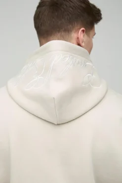 Shop boohooMAN Tall Oversized Boxy Twill Applique Contrast Stitch Hoodie stone