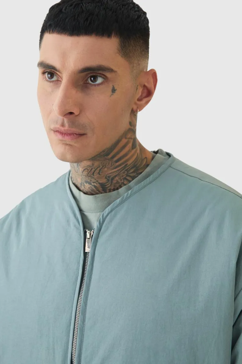 Store boohooMAN Tall Oversized Collarless Padded Bomber Jacket In slate