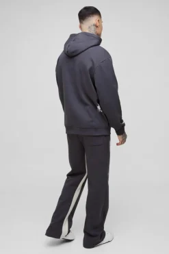 Shop boohooMAN Tall Oversized Man Paint Splatter Hooded Relaxed Flare Tracksuit black