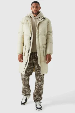 Store boohooMAN Tall 4 Pocket Longline Hooded Puffer Jacket in ecru