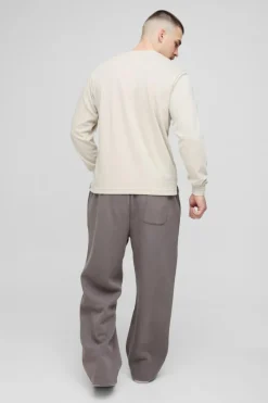 Shop boohooMAN Tall Relaxed Satin Applique WRLDWD Jogger charcoal