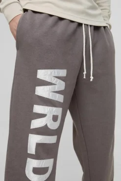 Shop boohooMAN Tall Relaxed Satin Applique WRLDWD Jogger charcoal