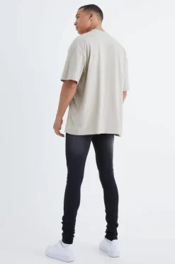 Shop boohooMAN Tall Super Skinny Stretch Jeans washed black