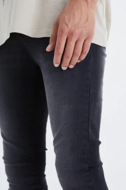 Shop boohooMAN Tall Super Skinny Stretch Jeans washed black