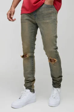 Store boohooMAN Tinted Rip Knee Stacked Skinny Zip Hem Jeans antique wash
