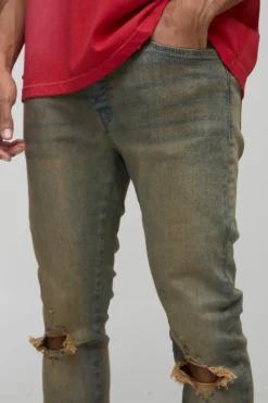 Store boohooMAN Tinted Rip Knee Stacked Skinny Zip Hem Jeans antique wash